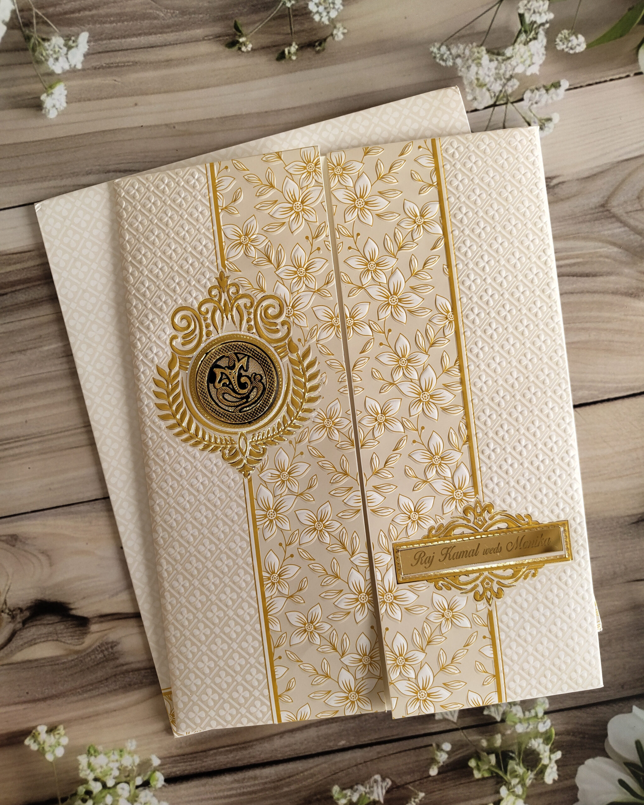 White & Yellow Ganesha Embossed Gold Foiled Wedding Invitation Card with Acrylic Nameplate, Customisable Emblem & Matching Envelope