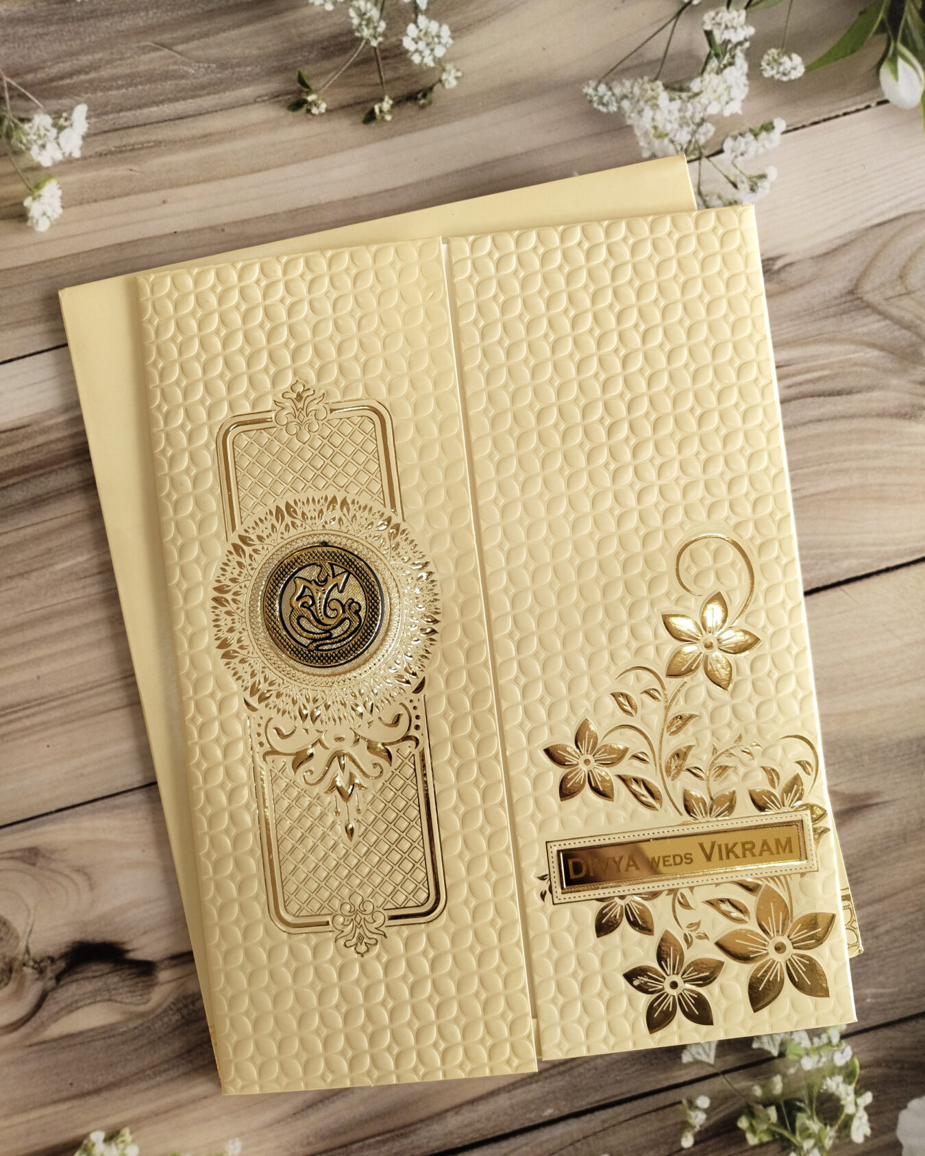 Elegant Cream Embossed Floral Gold Foiled Wedding Invitation Card with Acrylic Nameplate, Customisable Emblem & Matching Envelope